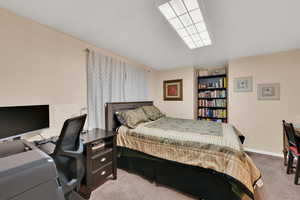 Bedroom featuring light carpet