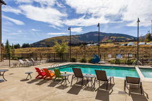 View of swimming pool featuring a mountain view and a patio area