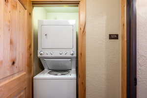 Clothes washing area featuring stacked washer / drying machine