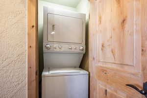 Laundry area with stacked washing maching and dryer