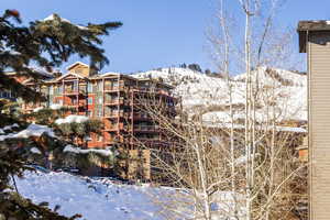 Snow covered property with a mountain view