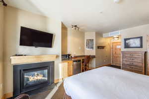 Bedroom featuring built in desk, track lighting, and carpet