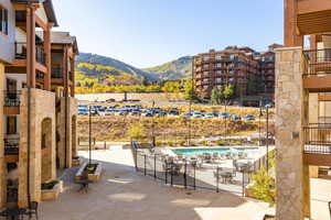 View of patio / terrace with a community pool and a mountain view