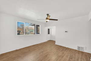 Unfurnished room featuring ceiling fan and light wood-type flooring