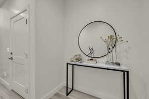 Hallway with light hardwood / wood-style floors