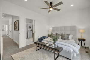 Carpeted living room featuring ceiling fan