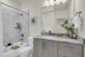 Full bathroom featuring vanity, toilet, and tiled shower / bath