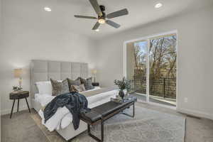 Carpeted bedroom with access to exterior and ceiling fan