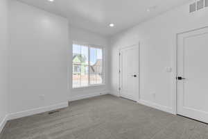 Spare room with light colored carpet