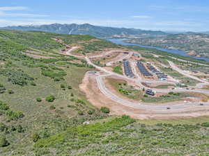 Drone / aerial view featuring a water and mountain view