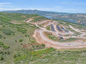 Birds eye view of property featuring a water and mountain view