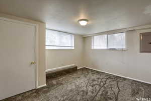 Carpeted empty room with a textured ceiling