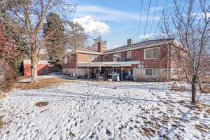 Snow covered house featuring cooling unit