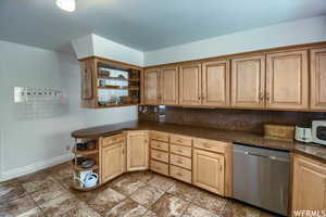 Kitchen with tasteful backsplash, stainless steel dishwasher, and mail boxes