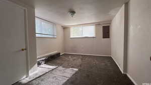 Carpeted empty room featuring electric panel