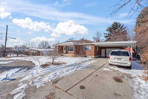 Single story home featuring a carport