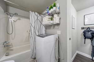 Laundry area featuring dark hardwood / wood-style floors