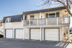 View of property featuring a balcony and a garage