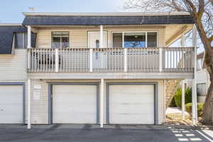 View of property featuring a balcony and a garage