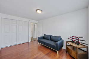 Living area with hardwood / wood-style floors and a textured ceiling