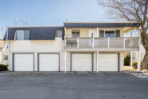 View of front of property with a balcony and a garage