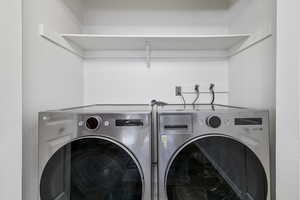 Clothes washing area featuring washing machine and dryer