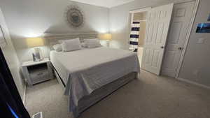 View of carpeted bedroom and entrance to bathroom