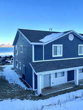 View of front facade featuring a garage and a mountain view