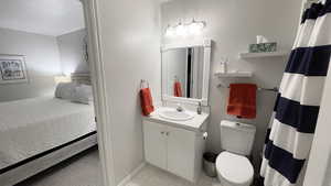 Bathroom featuring vanity and toilet