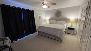 Bedroom featuring light carpet and ceiling fan