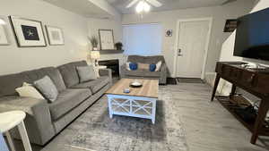 Living room featuring ceiling fan and light hardwood / wood-style floors