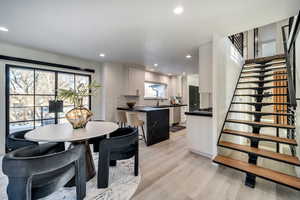 Dining space featuring sink and light wood-type flooring