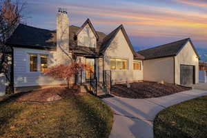 View of front of home featuring a garage and a yard