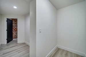 Hallway with light hardwood / wood-style floors