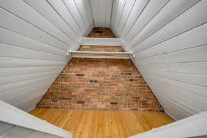 Stairs featuring hardwood / wood-style floors and wooden walls