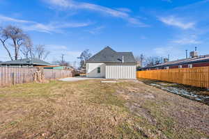 Back of house with a lawn