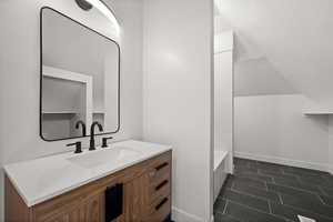 Bathroom with vanity and tub / shower combination