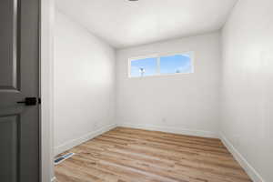 Spare room with light hardwood / wood-style flooring