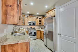 Kitchen with appliances with stainless steel finishes and sink