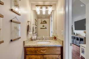 Bathroom featuring vanity and hardwood / wood-style floors