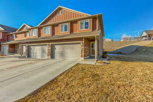 View of front of home featuring a garage and a front lawn