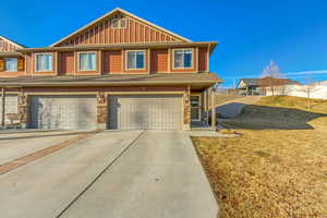 View of front of property featuring a garage and a front yard