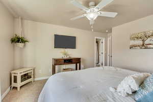 Carpeted bedroom featuring ceiling fan