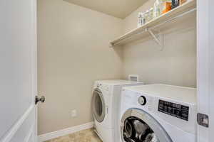 Laundry room with washing machine and clothes dryer