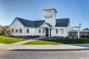 View of front of house featuring a pergola and a front lawn