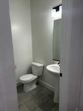 Bathroom featuring tile patterned flooring and toilet