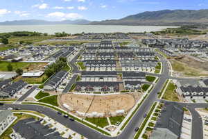 Birds eye view of property with a water and mountain view