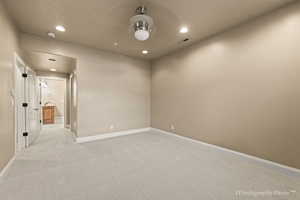 Empty room with light colored carpet