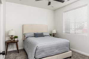 Bedroom featuring ceiling fan and carpet