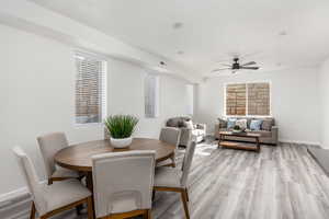 Dining room with light hardwood / wood-style floors and ceiling fan